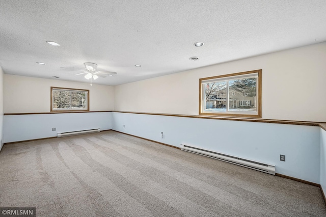 unfurnished room featuring plenty of natural light, visible vents, and baseboard heating