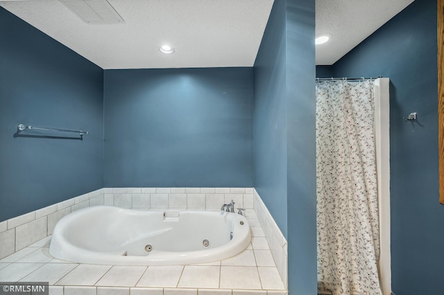 bathroom featuring a whirlpool tub, curtained shower, a textured ceiling, and visible vents