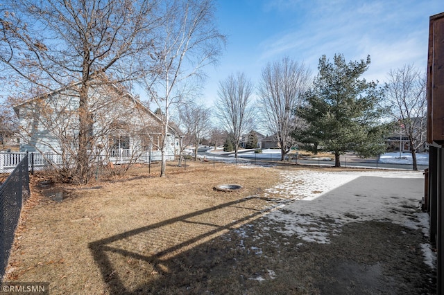 view of yard with fence and a pool