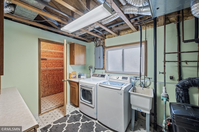 clothes washing area featuring a sink, washer and dryer, electric panel, cabinet space, and light floors