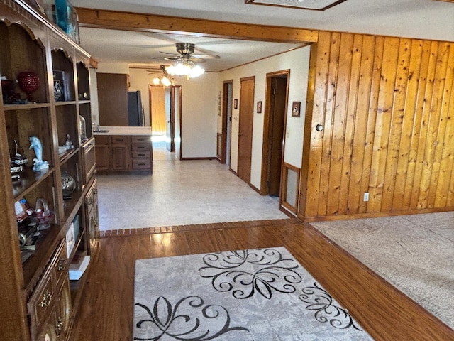 hallway featuring dark wood-type flooring, elevator, and wooden walls