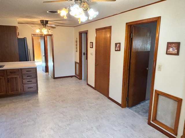 interior space with visible vents, a textured ceiling, and baseboards