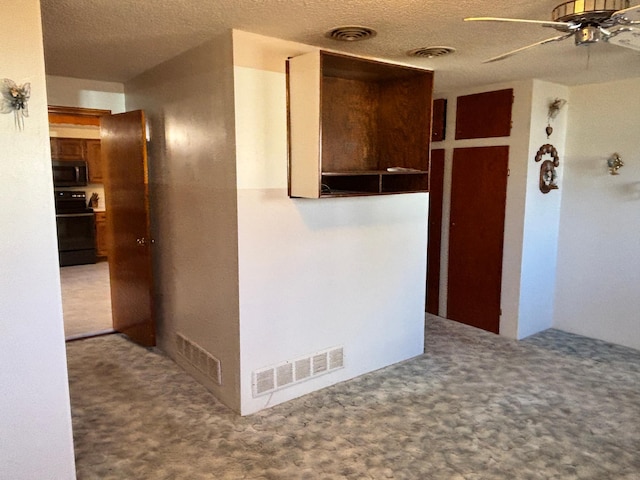 corridor featuring carpet, visible vents, and a textured ceiling