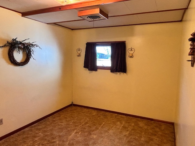 unfurnished room featuring carpet, visible vents, and baseboards