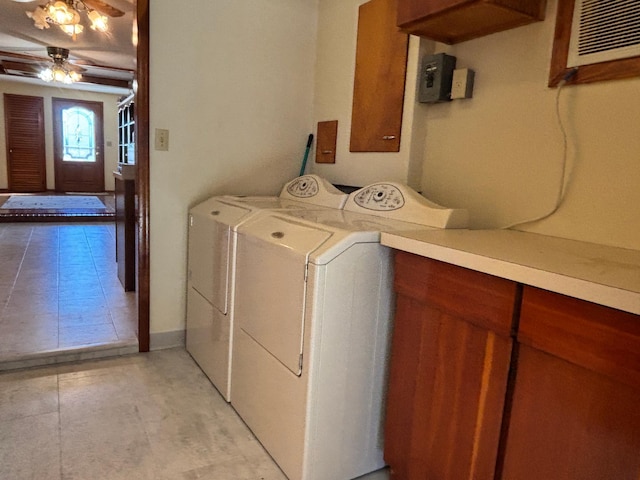 laundry area featuring a ceiling fan, an AC wall unit, cabinet space, and washing machine and clothes dryer