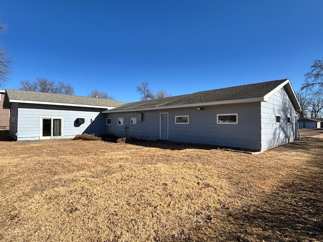 rear view of property featuring a yard