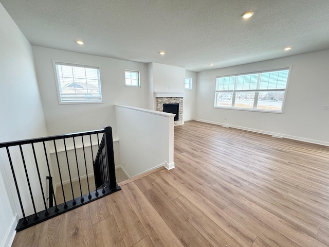 interior space featuring light wood-style floors, recessed lighting, and a textured ceiling