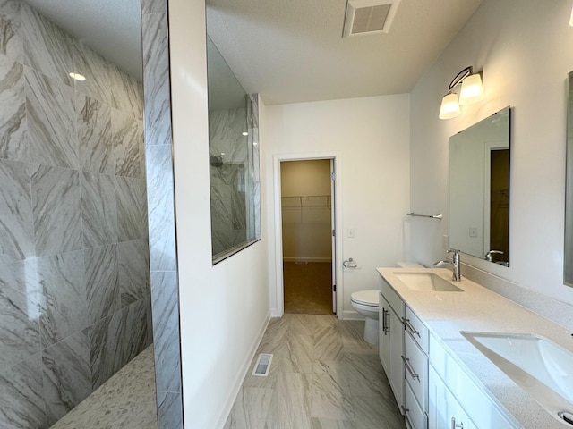 bathroom featuring walk in shower, a sink, and visible vents