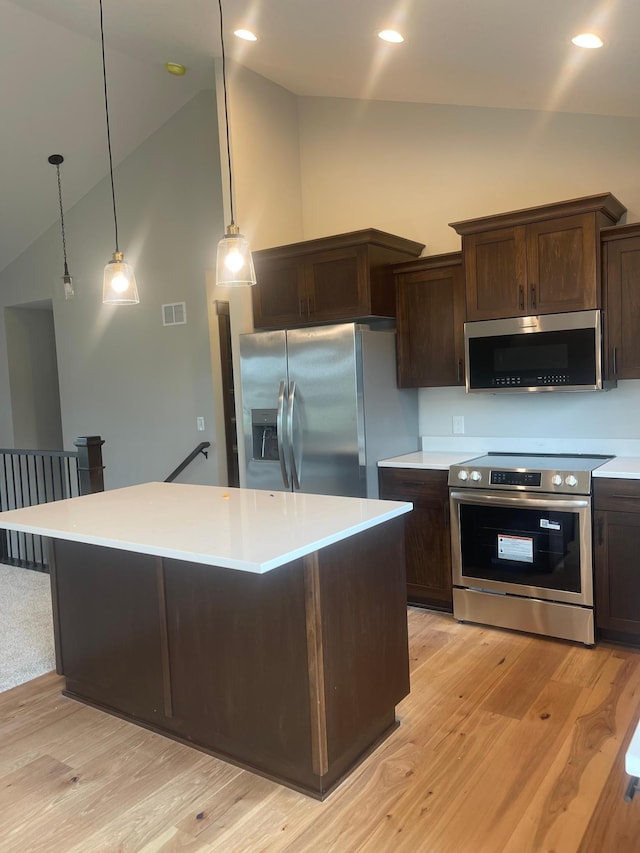 5266 177th St W, Lakeville, MN 55024 - kitchen featuring appliances with stainless steel finishes, high vaulted ceiling, dark brown cabinets, light countertops, and light wood-style floors
