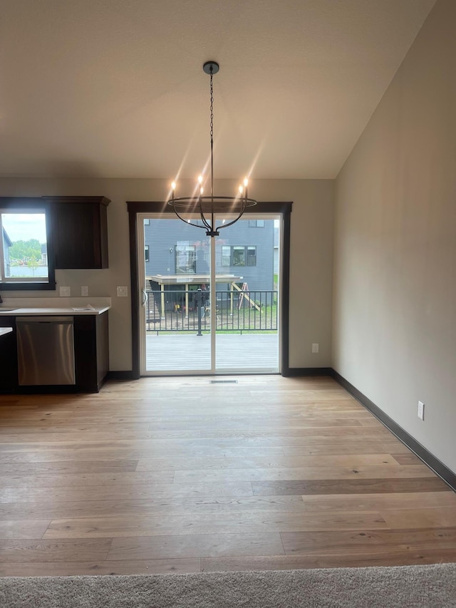 5266 177th St W, Lakeville, MN 55024 - unfurnished dining area featuring a chandelier, light wood-style floors, and baseboards