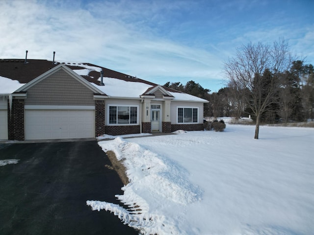 view of front of house featuring a garage, brick siding, and aphalt driveway