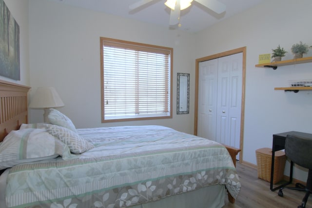 bedroom with a ceiling fan, a closet, and wood finished floors