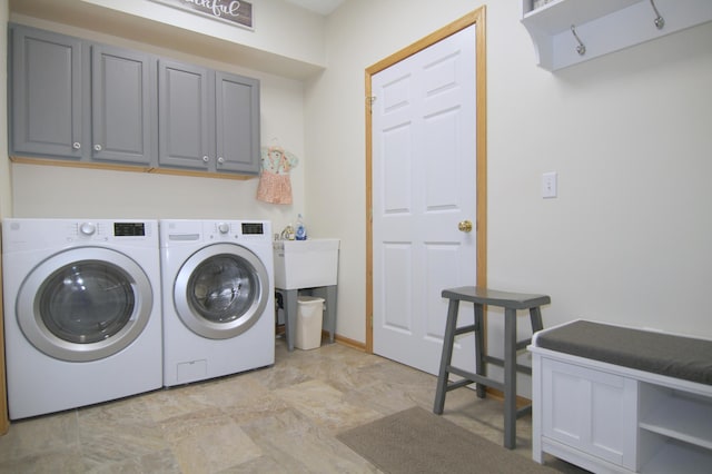 laundry room featuring separate washer and dryer and cabinet space