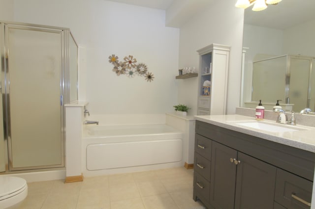 full bathroom featuring toilet, vanity, a shower stall, a bath, and tile patterned floors