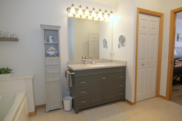 ensuite bathroom with baseboards, ensuite bath, tile patterned floors, vanity, and a closet