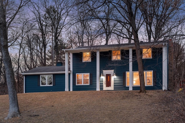 greek revival house featuring a chimney