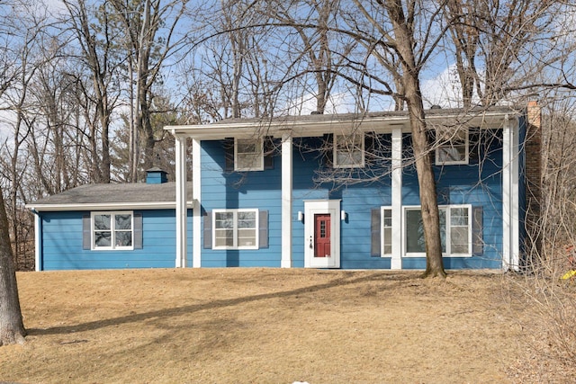 view of front of property with a front lawn and a chimney