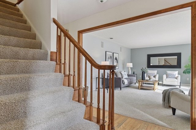 stairway with wood finished floors