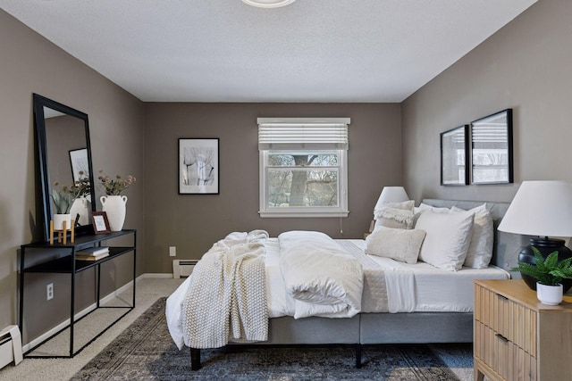 bedroom with baseboards, a baseboard radiator, a textured ceiling, a baseboard heating unit, and carpet flooring