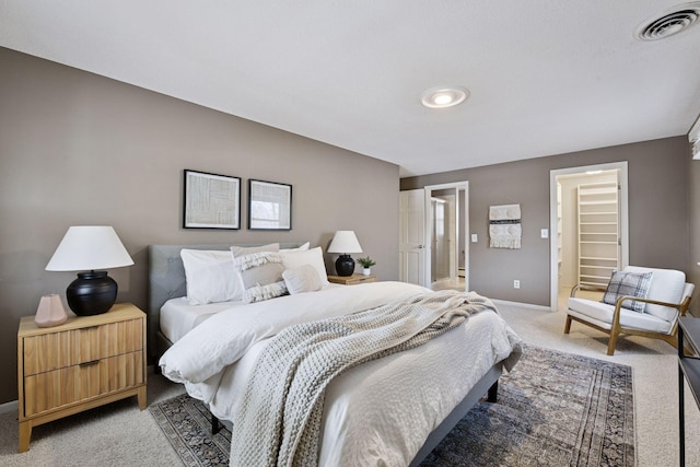 bedroom featuring visible vents, light colored carpet, and baseboards