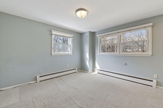 unfurnished room with carpet floors, a textured ceiling, baseboards, and a baseboard radiator