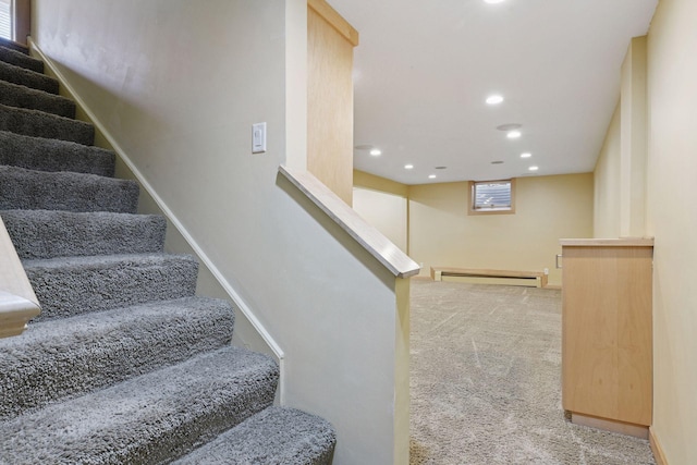 staircase featuring recessed lighting, a baseboard heating unit, baseboards, and carpet flooring