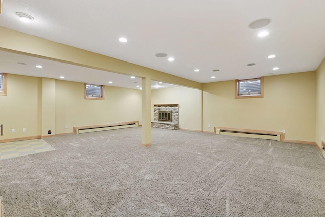 basement featuring carpet flooring, recessed lighting, and a baseboard heating unit