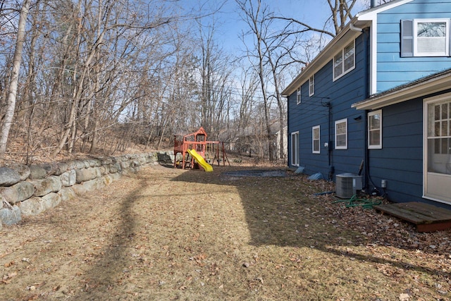 view of yard with central AC and a playground