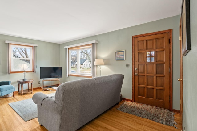 living area with wood finished floors and baseboards