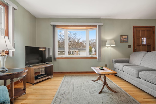 living room featuring light wood-type flooring and baseboards