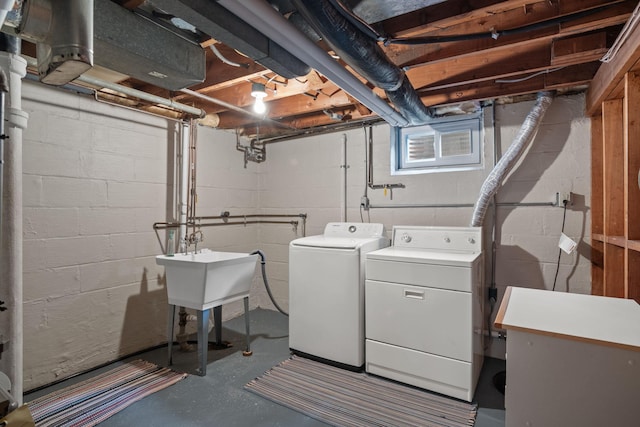 laundry room featuring laundry area, independent washer and dryer, and a sink