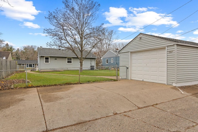 detached garage with driveway and fence