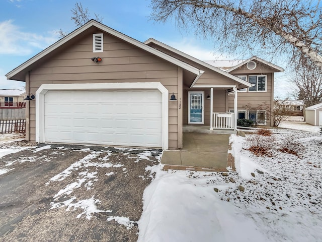 view of front of house featuring covered porch and an attached garage