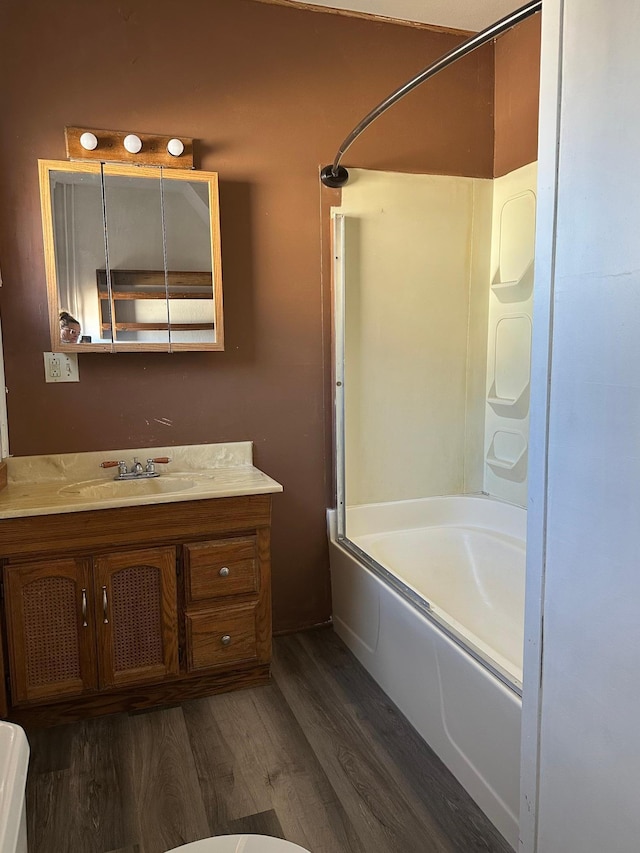 full bathroom with tub / shower combination, vanity, and wood finished floors