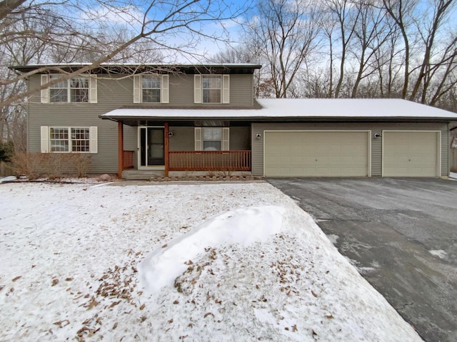 traditional-style home with an attached garage, driveway, and a porch