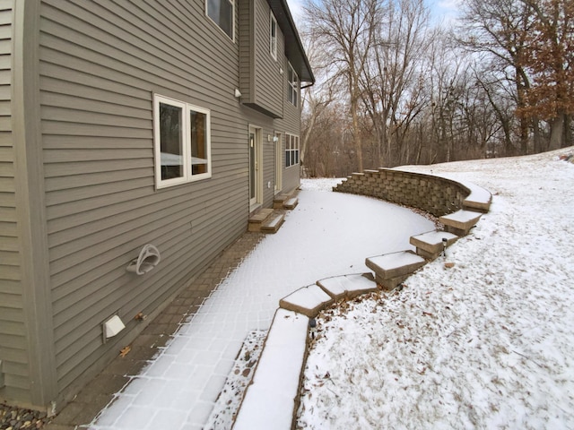 view of snow covered exterior with a patio area