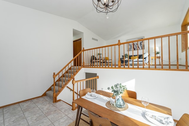 dining room with visible vents, baseboards, a chandelier, stairway, and vaulted ceiling