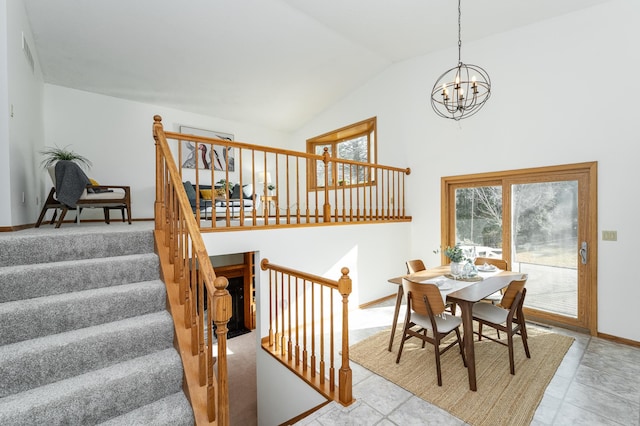 dining space with stairway, baseboards, a notable chandelier, and vaulted ceiling