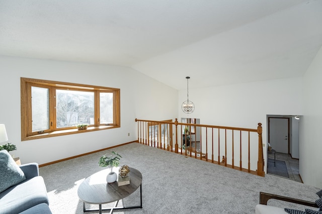 carpeted living area with a notable chandelier, baseboards, and vaulted ceiling