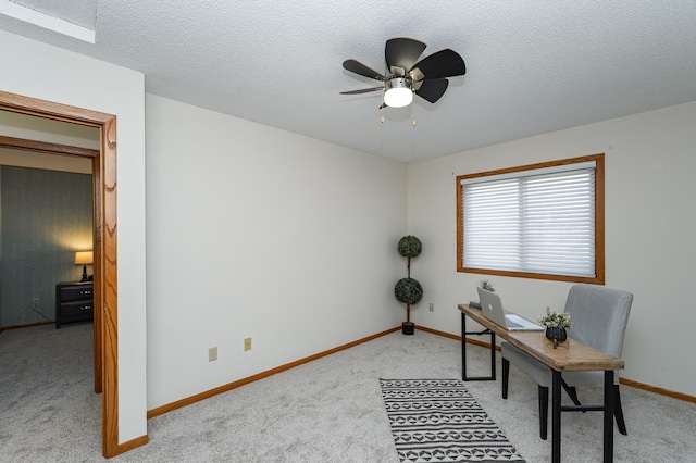 office area with light carpet, baseboards, a textured ceiling, and a ceiling fan