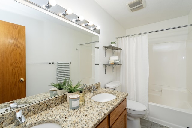 full bath with double vanity, visible vents, toilet, and a sink