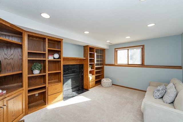 living area featuring recessed lighting, baseboards, a fireplace with flush hearth, and carpet