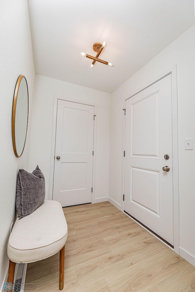 interior space with light wood finished floors and baseboards