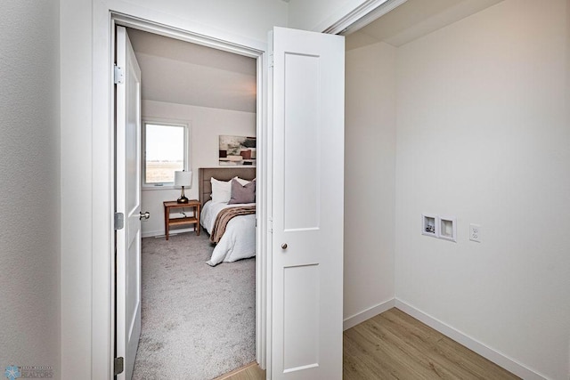 hall with light carpet and baseboards