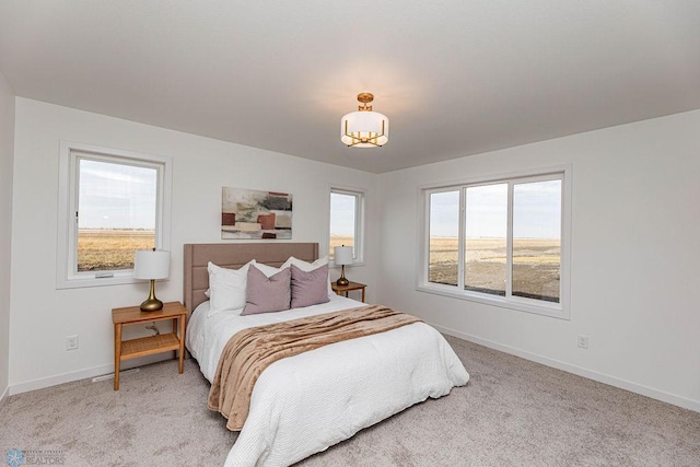bedroom with baseboards and carpet flooring