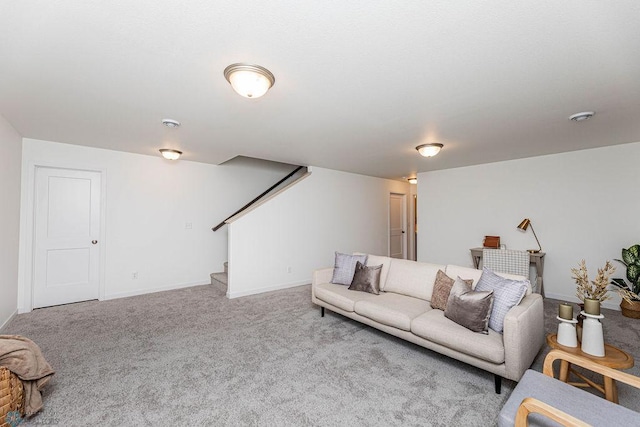 living room with baseboards, stairway, and carpet flooring