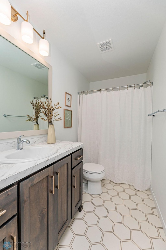 full bathroom with visible vents, vanity, and toilet