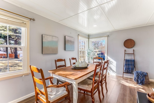 dining room featuring wood finished floors and baseboards