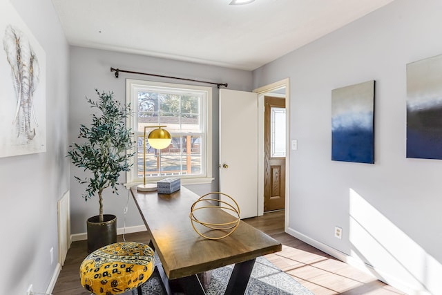 home office featuring baseboards and wood finished floors