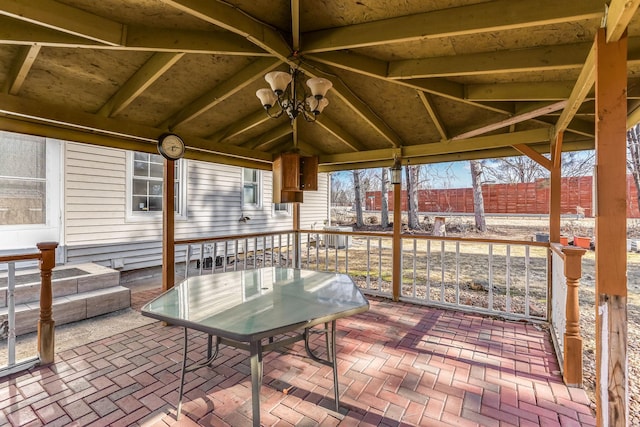 sunroom featuring a chandelier